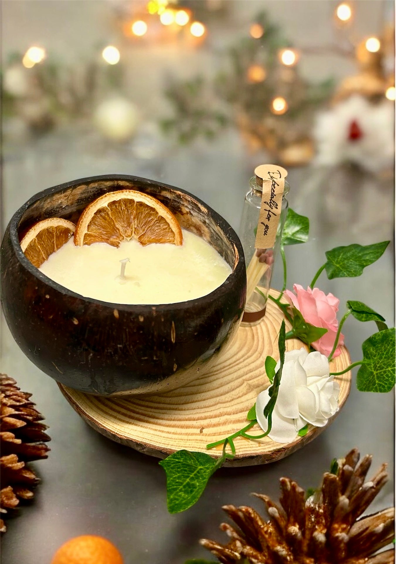 ORANGE Scented Coco shell candle with wooden slice and bottle of matches.