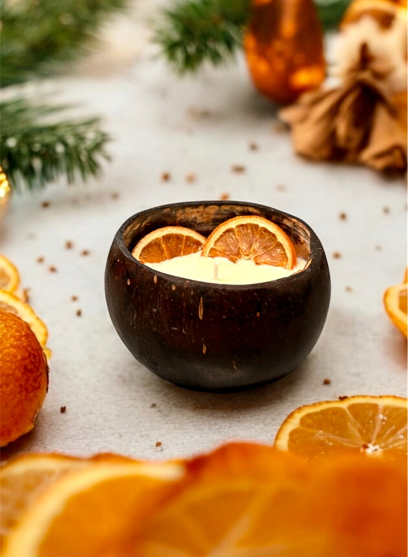 ORANGE Scented Coco shell candle with wooden slice and bottle of matches.